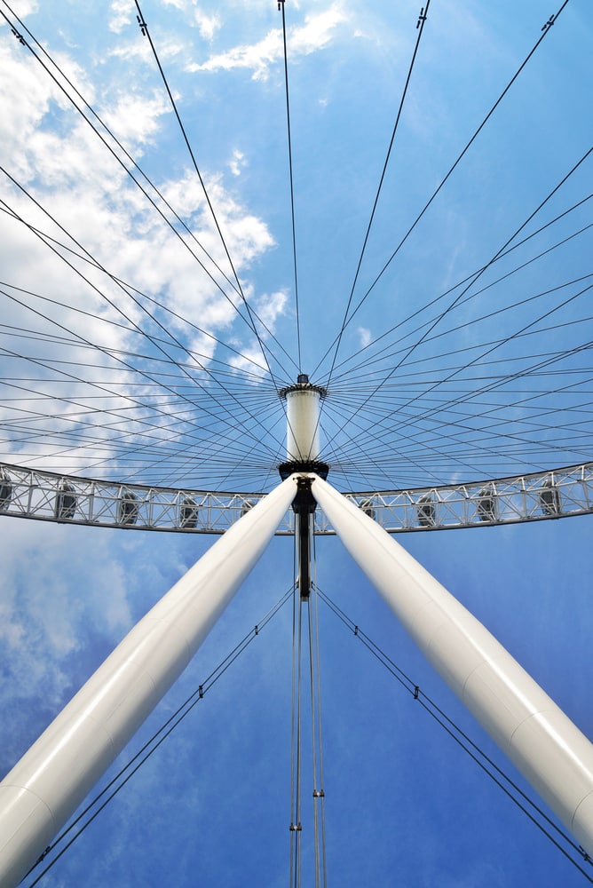 Looking up into the spokes of a large Ferris wheel