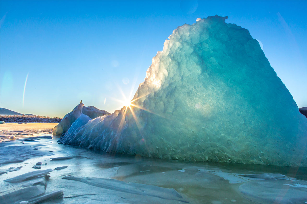 Ice that has calved off from a glacier with the sun shining through it.