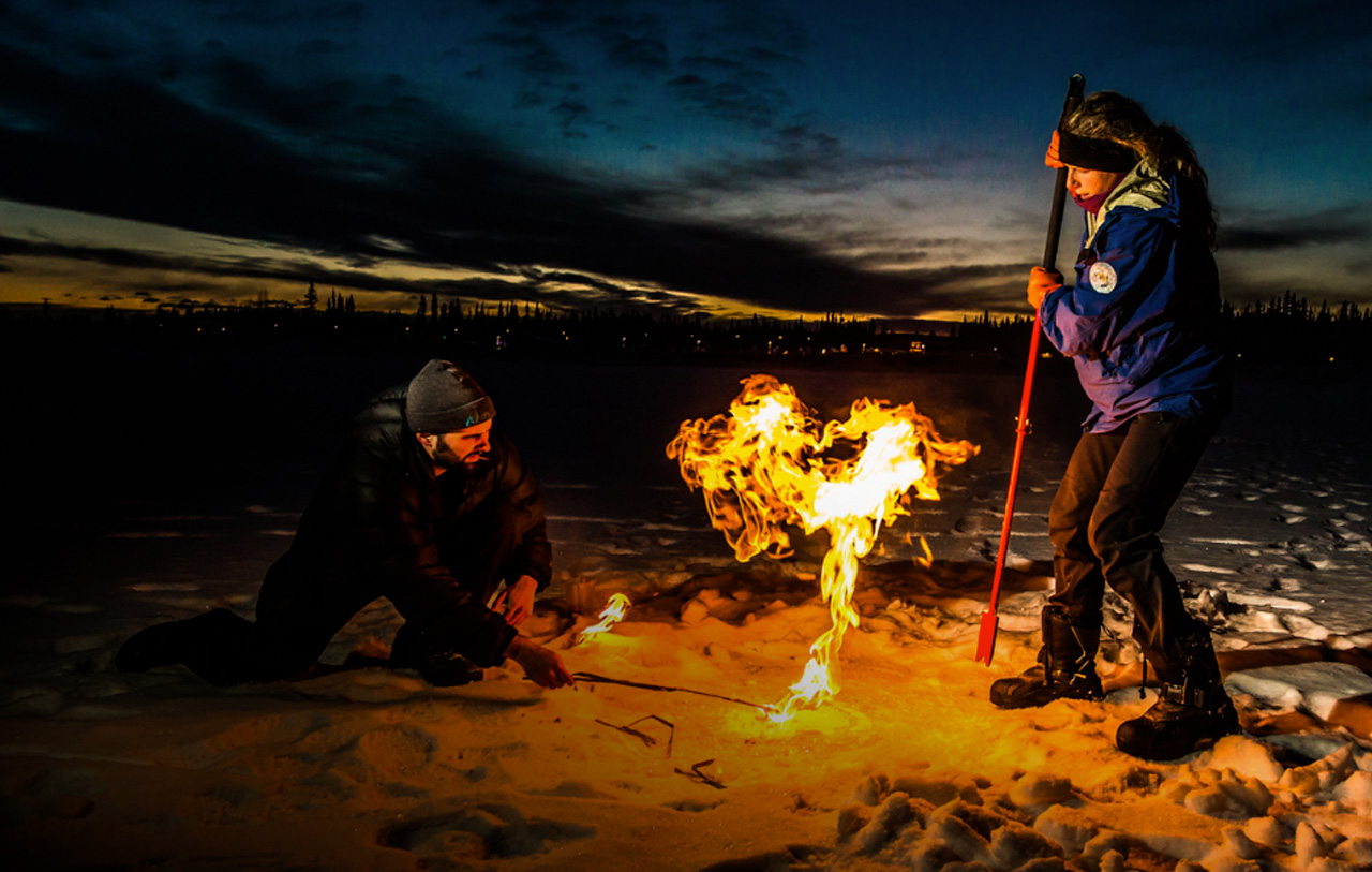 methane is released from a frozen pond in Fairbanks, AK